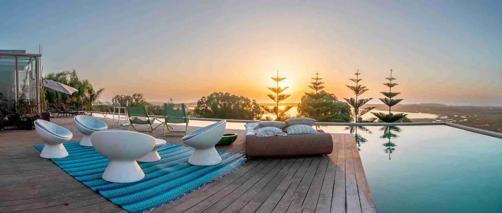 Kohinor’s pool at sunset with loungers and views of the coast